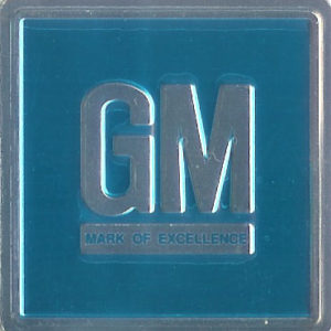 1967 G.M. Emblem W/ Teal Background